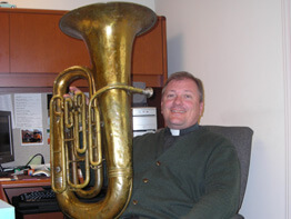 Tuba-toting priest is top brass