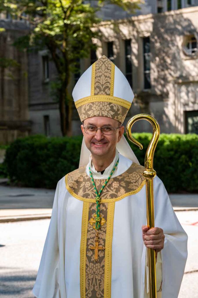 Bishop-designate Lewandowski's insignia denote his office ...