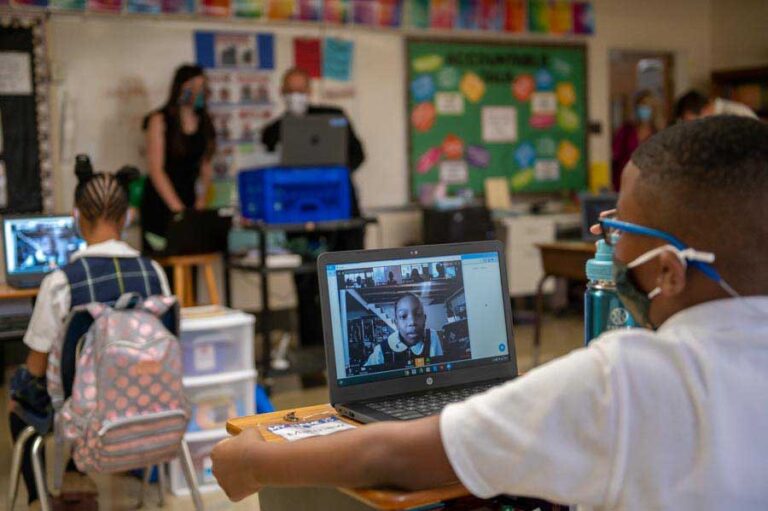 A fifth-grader at Holy Angels Catholic School connects with classmates virtually