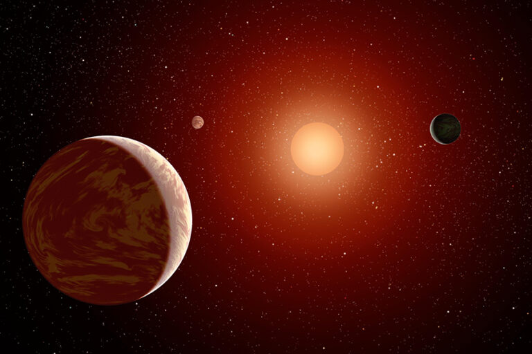 This NASA artist's concept illustrates a young, red dwarf star surrounded by three planets.