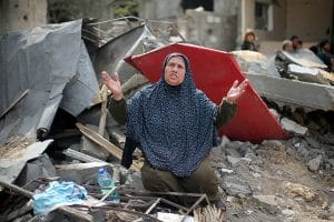 A Palestinian woman reacts after returning to her destroyed house in Gaza.