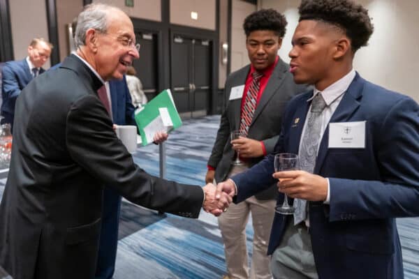 Archbishop William E. Lori meets Archbishop Curley High School students Kamron Hampton