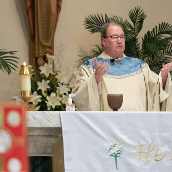 Monsignor Hartnett at his peak while connecting with parishioners through sacraments