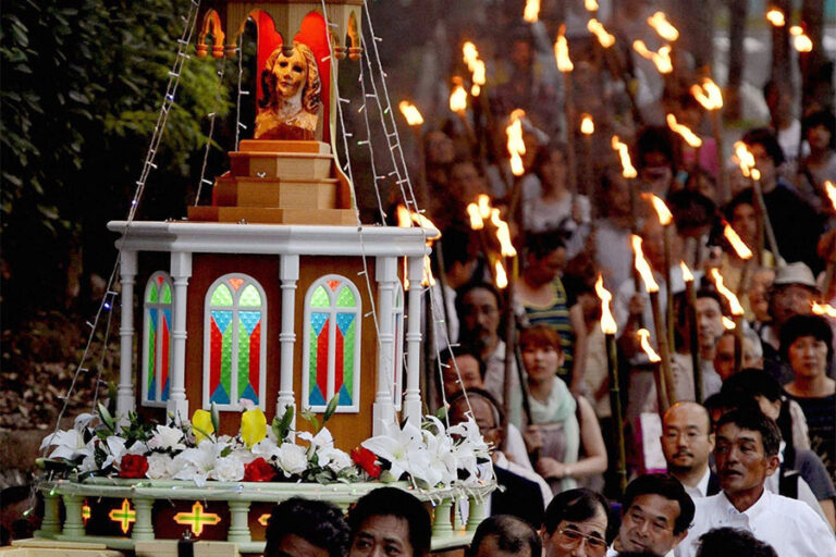 People carry the remains of a statue of Mary that survived the Nagasaki atomic bomb as they march through the streets of the city Aug. 9, 2012. Archbishop John C. Wester of Santa Fe, N.M., is making another pilgrimage of peace to Japan to mark the 79th anniversary of the atomic bombings of Hiroshima and Nagasaki. (OSV News photo/Kyodo, Reuters)