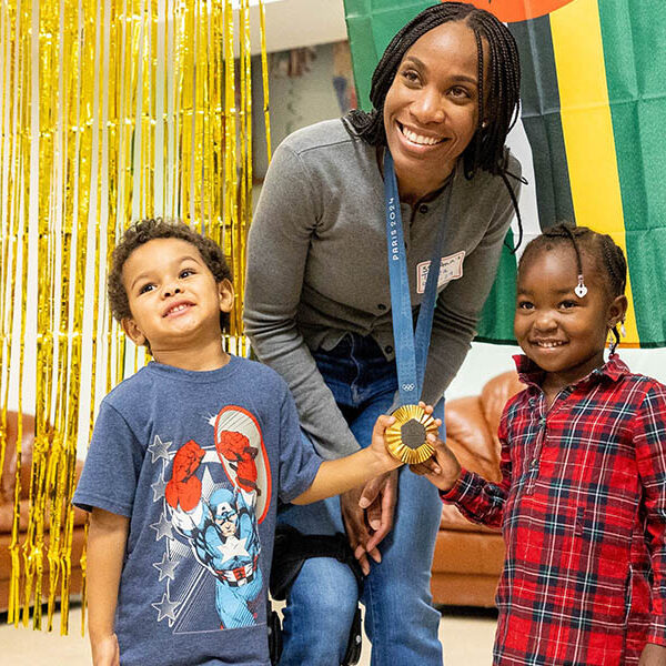 In spirit of giving back to community, Maryland Olympian visits Catholic center for moms, children