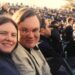 My brother-in-law and sister smiling for the camera at a football game in a stadium in New Haven Connectict