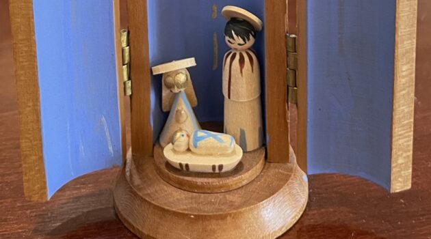 Tiny wooden nativity shows the Blessed Mother, St. Joseph, and an Infant Jesus