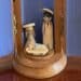 Tiny wooden nativity shows the Blessed Mother, St. Joseph, and an Infant Jesus