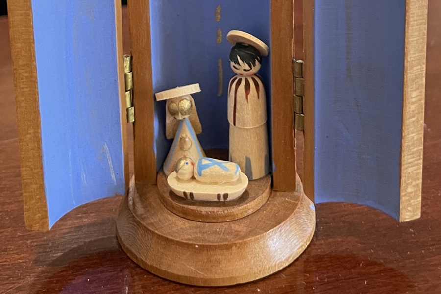 Tiny wooden nativity shows the Blessed Mother, St. Joseph, and an Infant Jesus