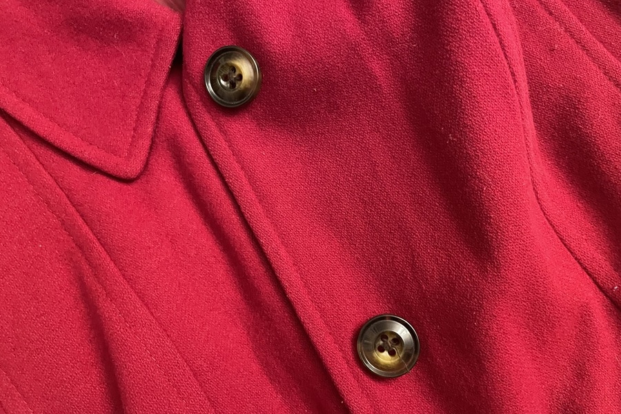 Image of two buttons on a red winter coat