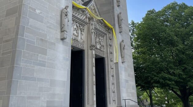 Yellow and white cloth hangs over the doors of Cathedral of Mary Our Queen in honor of the papal election