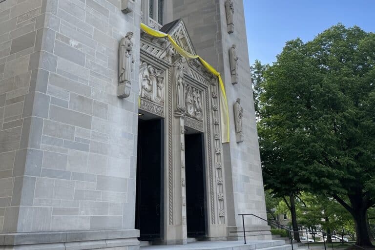 Yellow and white cloth hangs over the doors of Cathedral of Mary Our Queen in honor of the papal election