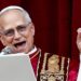 Pope Leo smiles as he speaks into a microphone