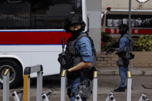 Police officers stand guard outside Jimmy Lai trial