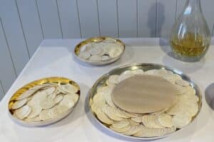 hosts sit on plates ready for communion at church