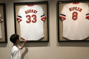 Child points to Murray and Ripken jerseys framed on the wall