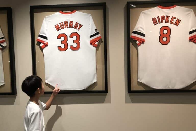 Child points to Murray and Ripken jerseys framed on the wall