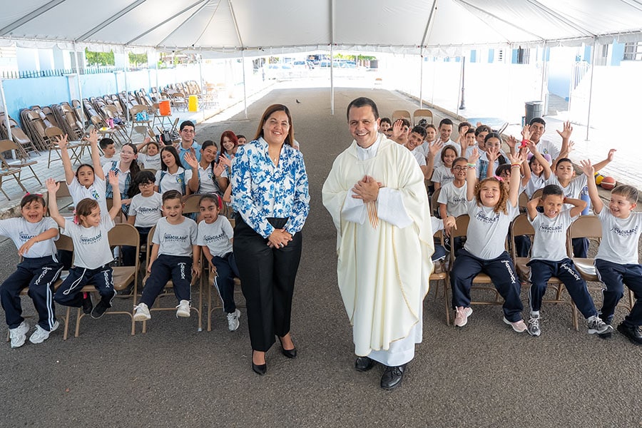 Priest, principal share award for rebuilding church and school