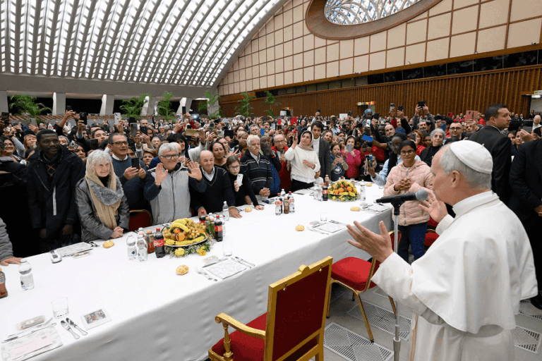 Pope Leo XIV welcomes his guests and blesses the meal at a luncheon