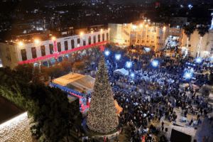 Palestinians attending a Christmas tree lighting in Manger Square outside the Church of the Nativity in Bethlehem