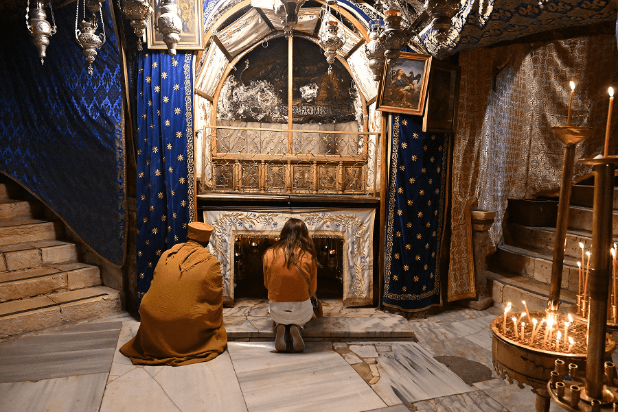 Christians pray in the grotto of the Church of Nativity in Bethlehem