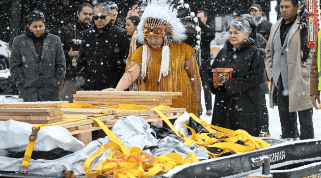 National Chief of the Assembly of First Nations Cindy Woodhouse Nepinak places her hand on Indigenous and cultural artifacts