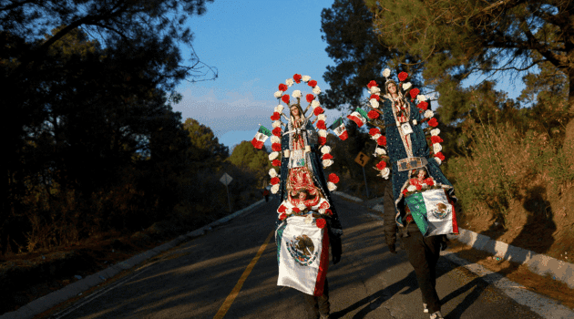 Pilgrims walk through the mountain pass between the Popocatepetl and Iztaccihuatl volcanos