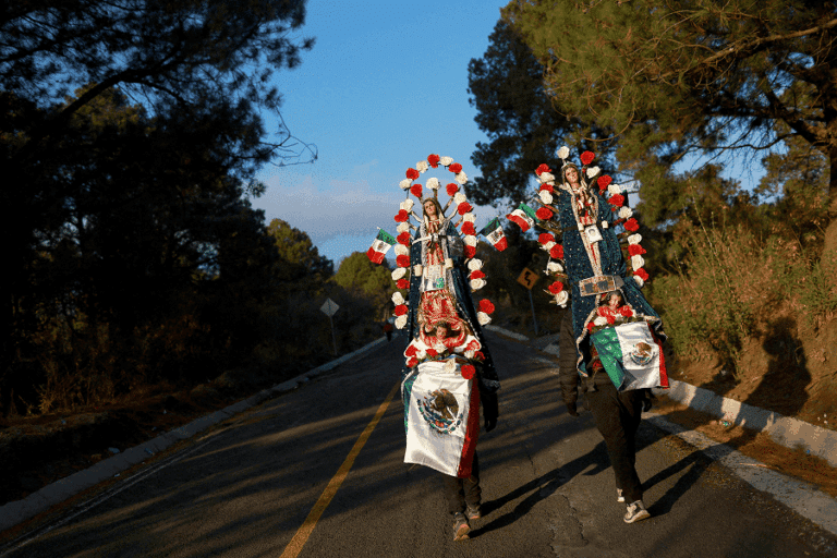 Pilgrims walk through the mountain pass between the Popocatepetl and Iztaccihuatl volcanos