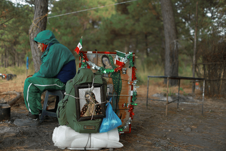 Pilgrims rest while walking through the mountain pass between the Popocatepetl and Iztaccihuatl volcanos