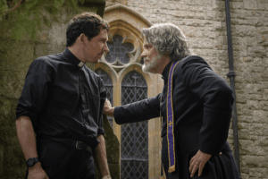 Father Jud Duplenticy (Josh O'Connor), and Msgr. Jefferson Wicks (Josh Brolin) star in a scene from the movie "Wake Up Dead Man: A Knives Out Mystery."