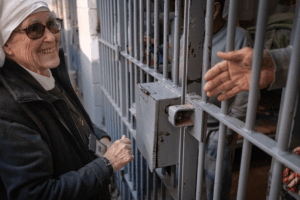 Sister Viola Lovato Ramirez, general leader of the Eudist Servants of the 11th Hour, chats with inmates