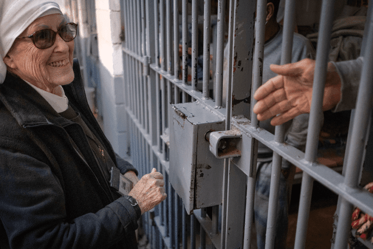 Sister Viola Lovato Ramirez, general leader of the Eudist Servants of the 11th Hour, chats with inmates