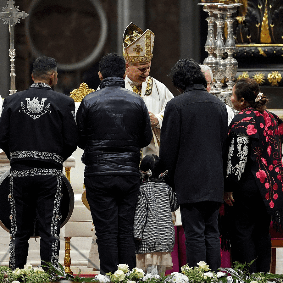 Pope Leo XIV receives the offertory gifts from a group of people dressed in traditional Mexican clothing