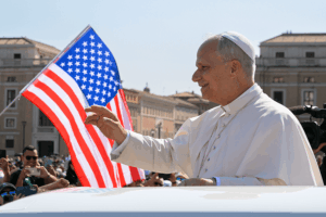 Pope Leo XIV waves to the crowd from the popemobile