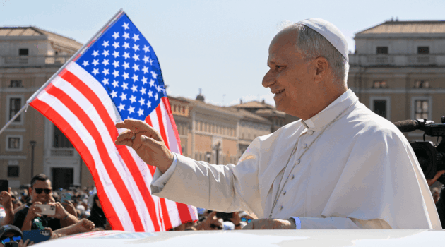 Pope Leo XIV waves to the crowd from the popemobile