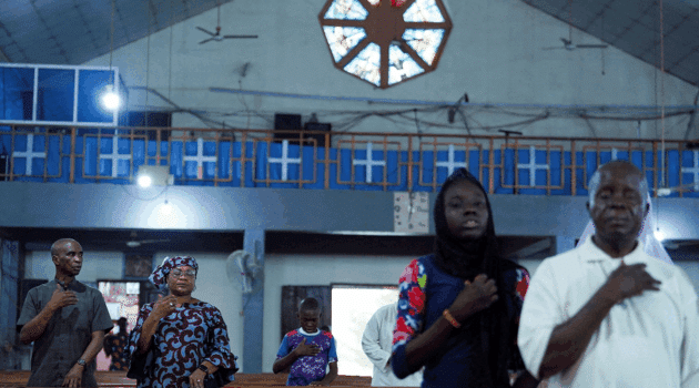 Worshippers attend an evening Mass