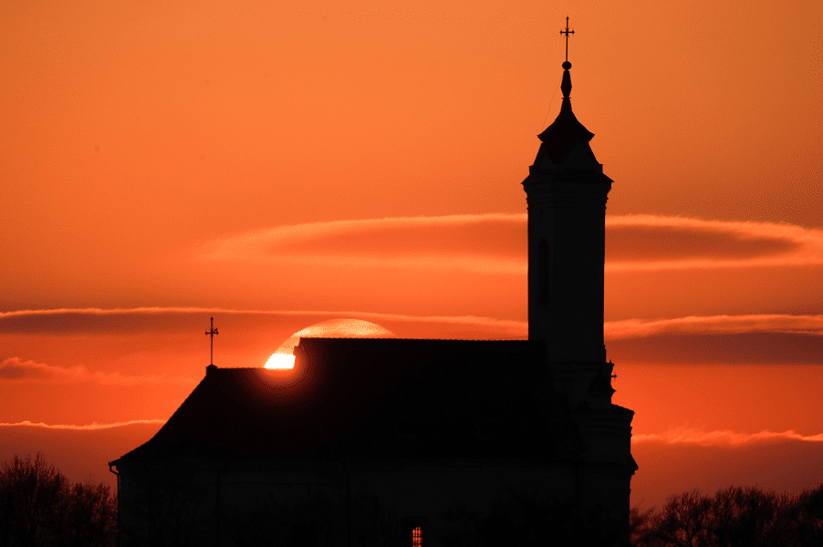 A Catholic church is silhouetted during sunset in Zaslavl, Belarus