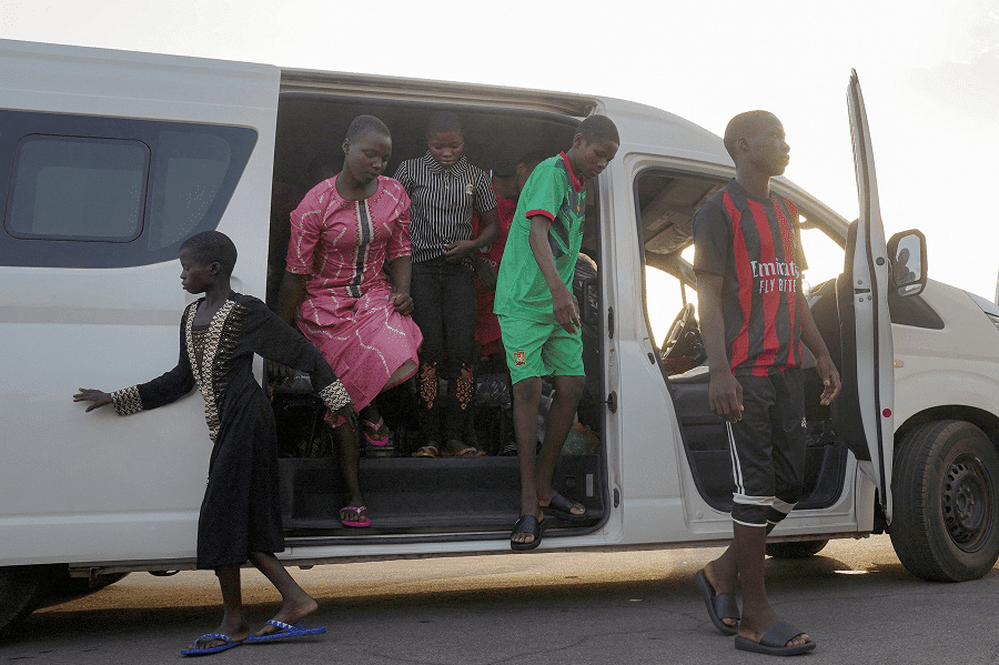 Schoolchildren from St. Mary's Catholic School in Papiri, Nigeria, arrive at the Niger State Government House