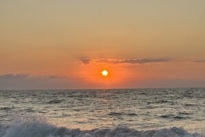 The sun rises over the ocean