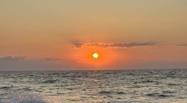 The sun rises over the ocean