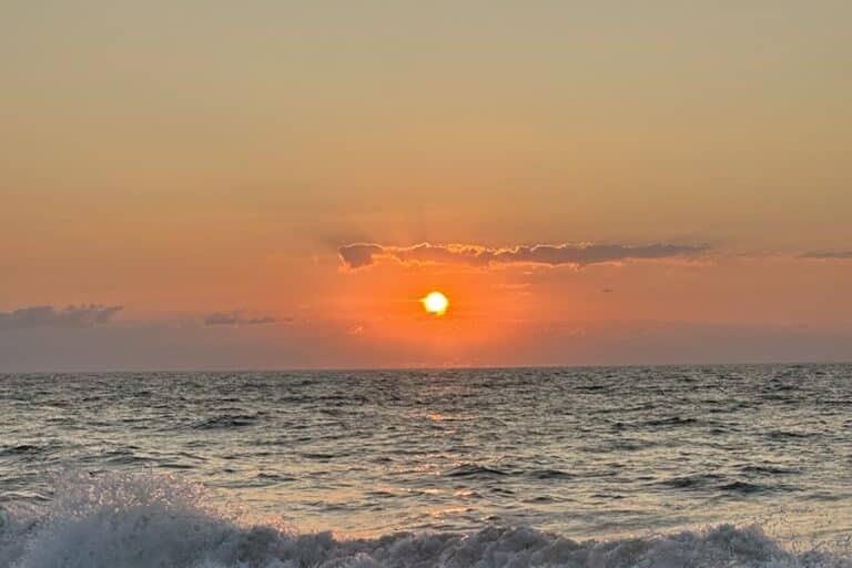 The sun rises over the ocean