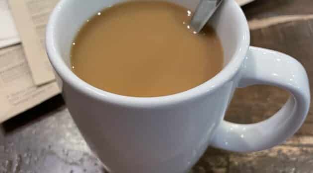 White mug of coffee on a table in a restaurant