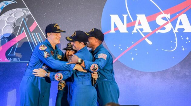 The four astronauts hug after returning from their trip on Artemis II