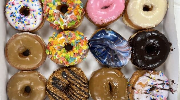 One dozen varied donuts in a box