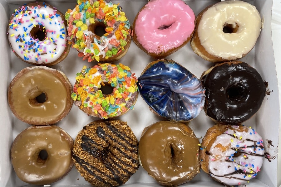 One dozen varied donuts in a box