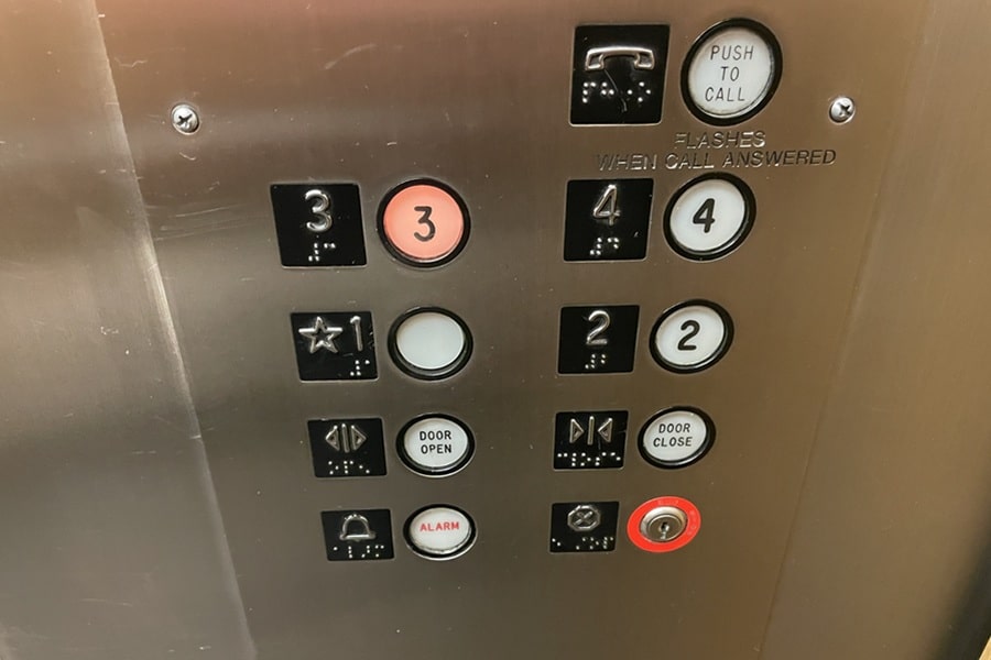 Buttons on an elevator with the 3 lit up