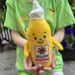 A child holds a plush mustard figure