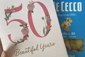 Birthday card that says 50 beautiful years on it with a box of pasta in the background