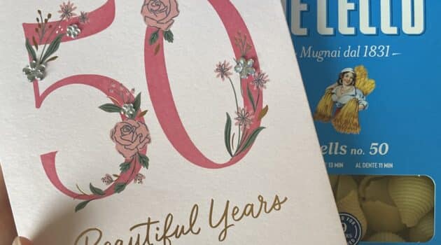 Birthday card that says 50 beautiful years on it with a box of pasta in the background