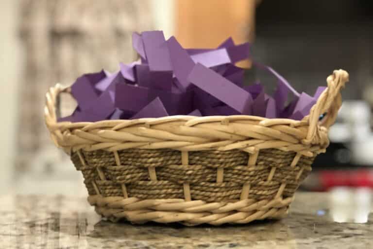 A basket of purple slips of paper sits on a counter